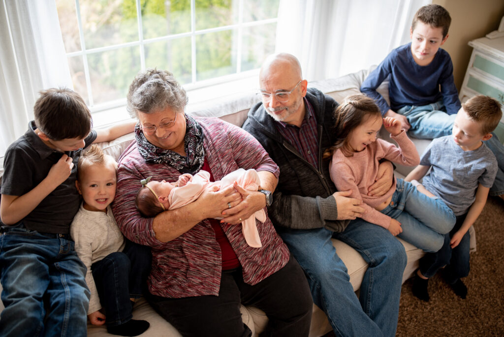 Grandparents and grandkids posing for lifestyle newborn photos