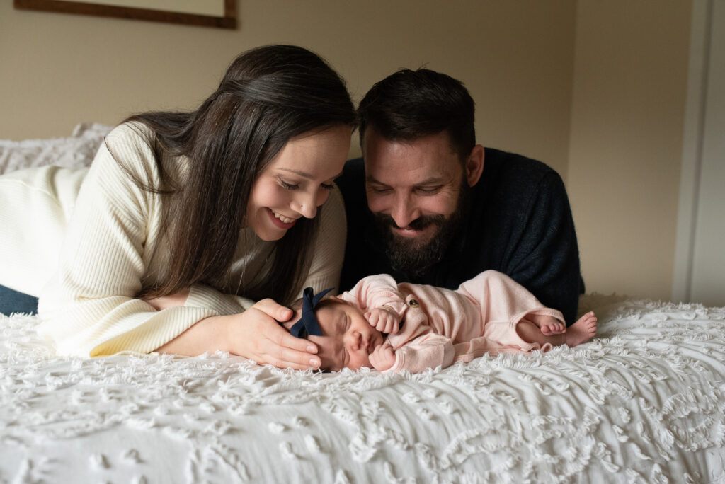 Parents gazing at new baby girl in lifestyle photo