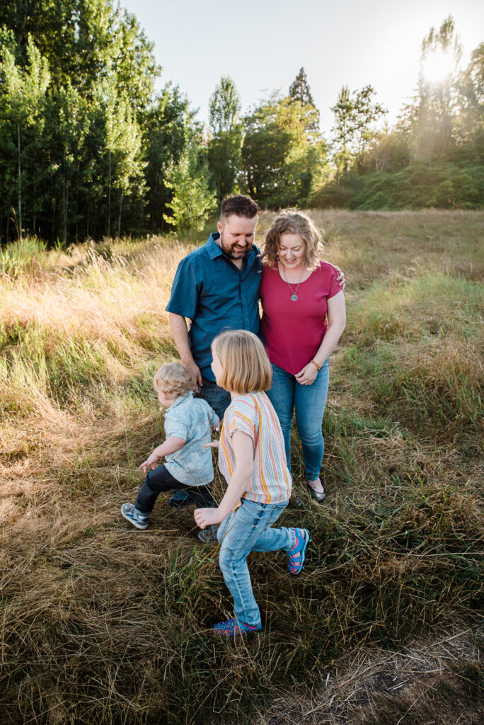 Kids running around their parents during family photo session