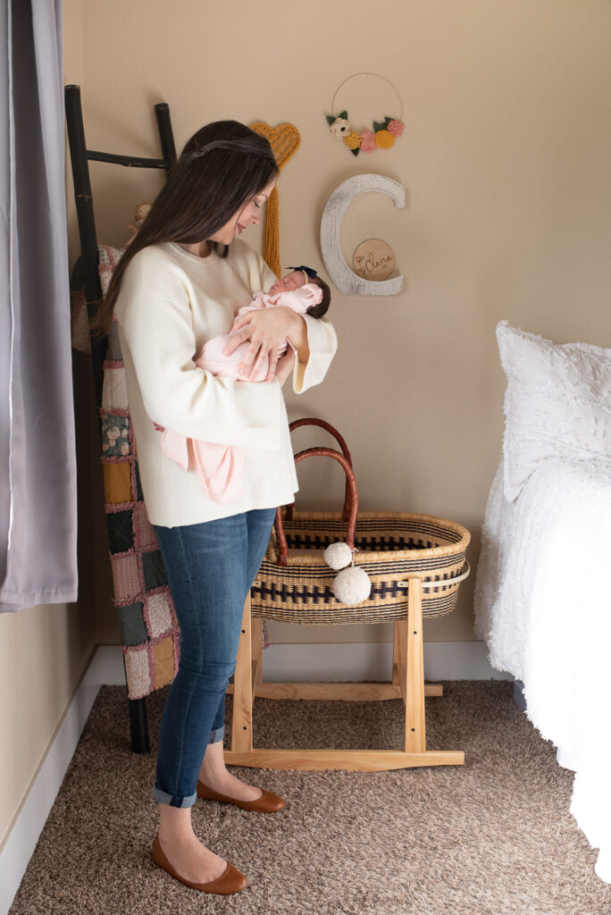 Mom standing holding her baby girl in nursery for Puyallup newborn photos