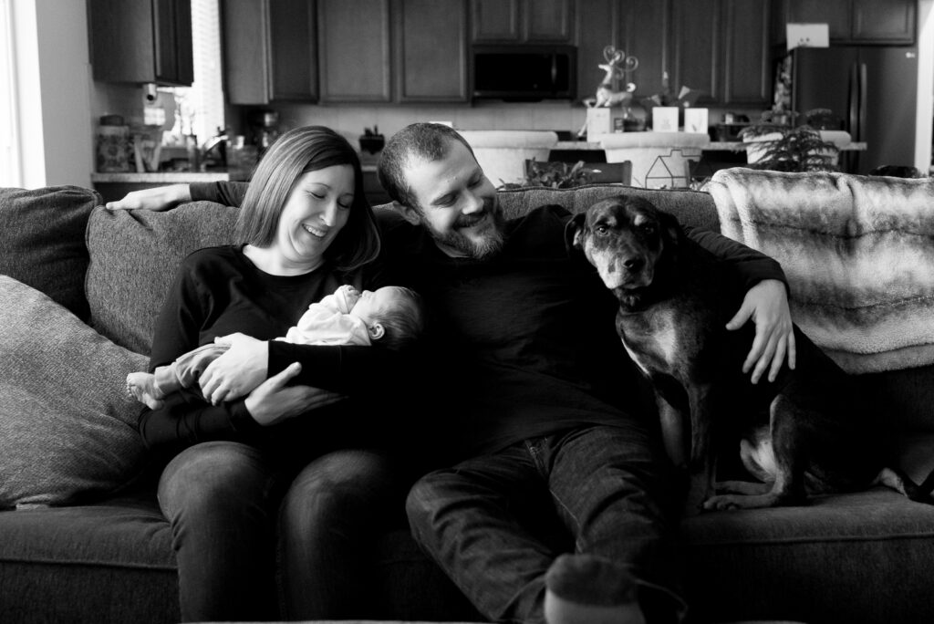 Lifestyle newborn session with whole family including dog on couch, Tacoma in-home photographer.