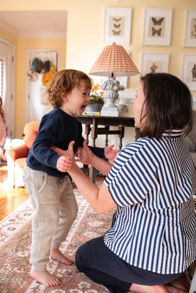 Candid in-home family photo capturing a real moment in the living room during a lifestyle session.